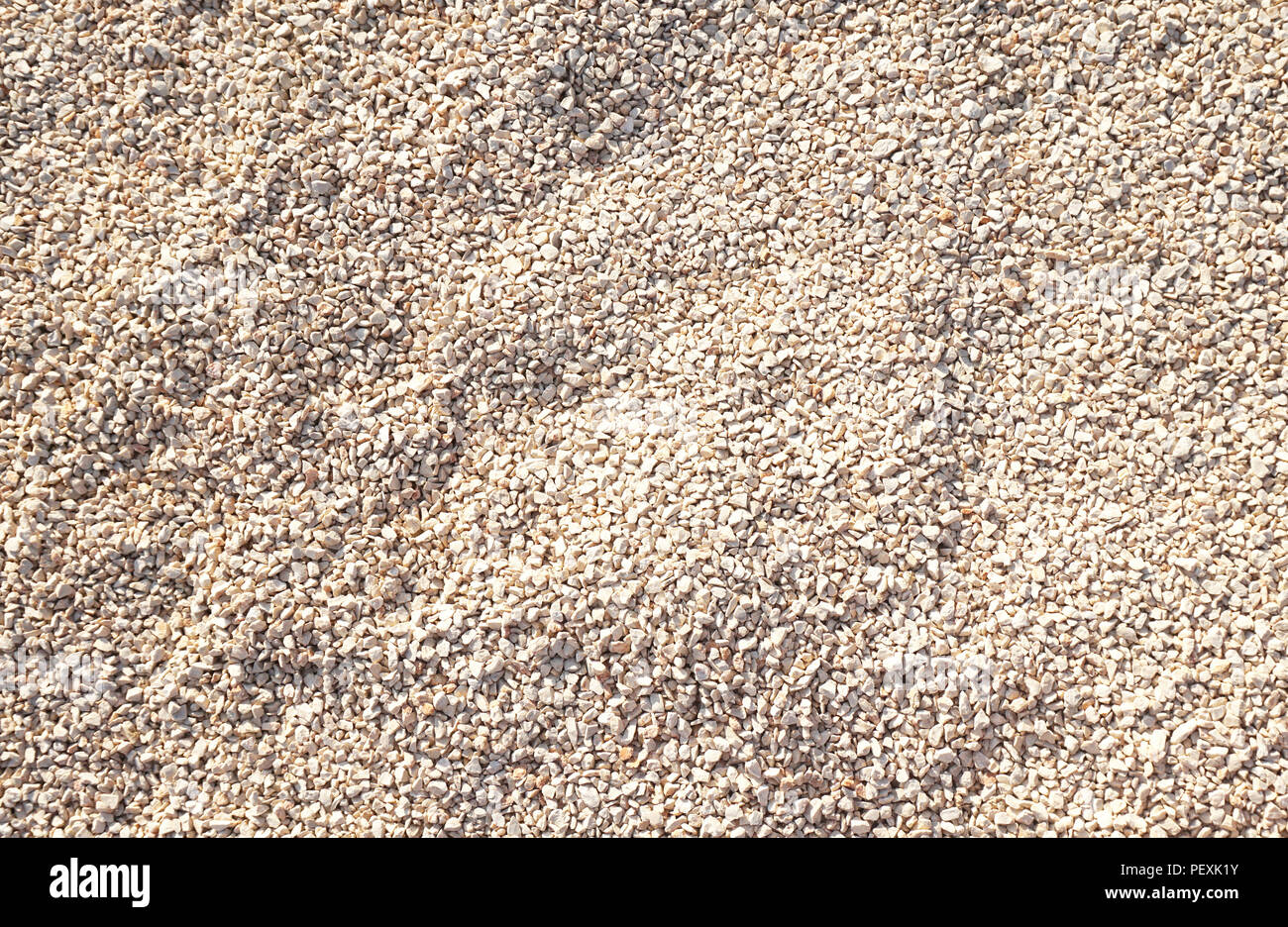 Surface of fine gravel in natural beige color. Nature pebble background Stock Photo