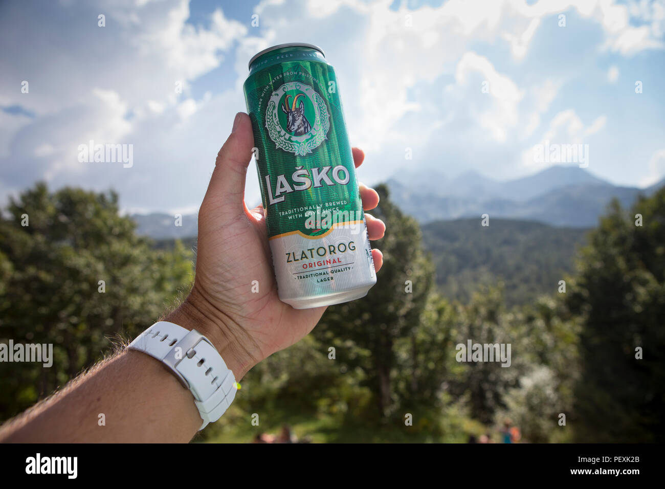Hiker holding can of Slovenian beer, Triglav National Park, Slovenia Stock Photo
