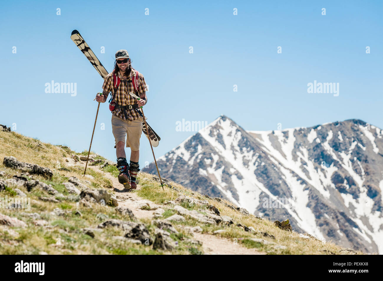 Man hiking with skis, La Plata Mountains, Colorado, USA Stock Photo