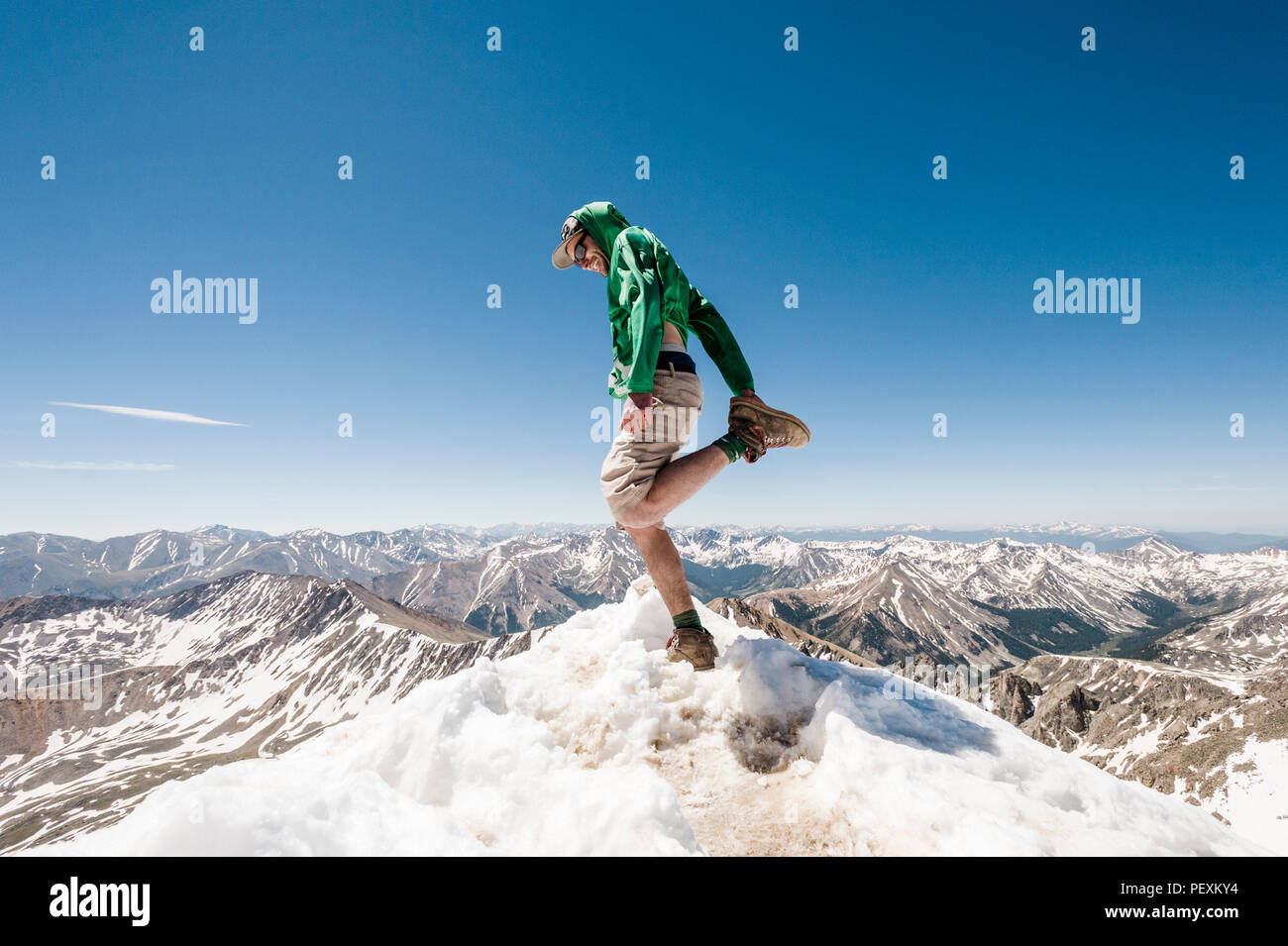 Hiker stretching on mountain peak, La Plata Mountains, Colorado, USA Stock Photo