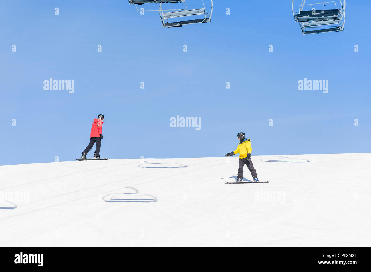 Men snowboarding down ski slope, Crested Butte, Colorado, USA Stock Photo