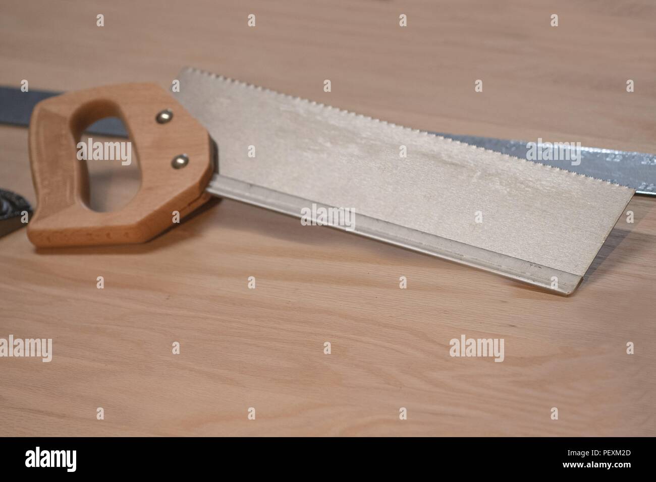 A Dovetail Saw Rests On An Oak Workbench In A Carpenter S Wood