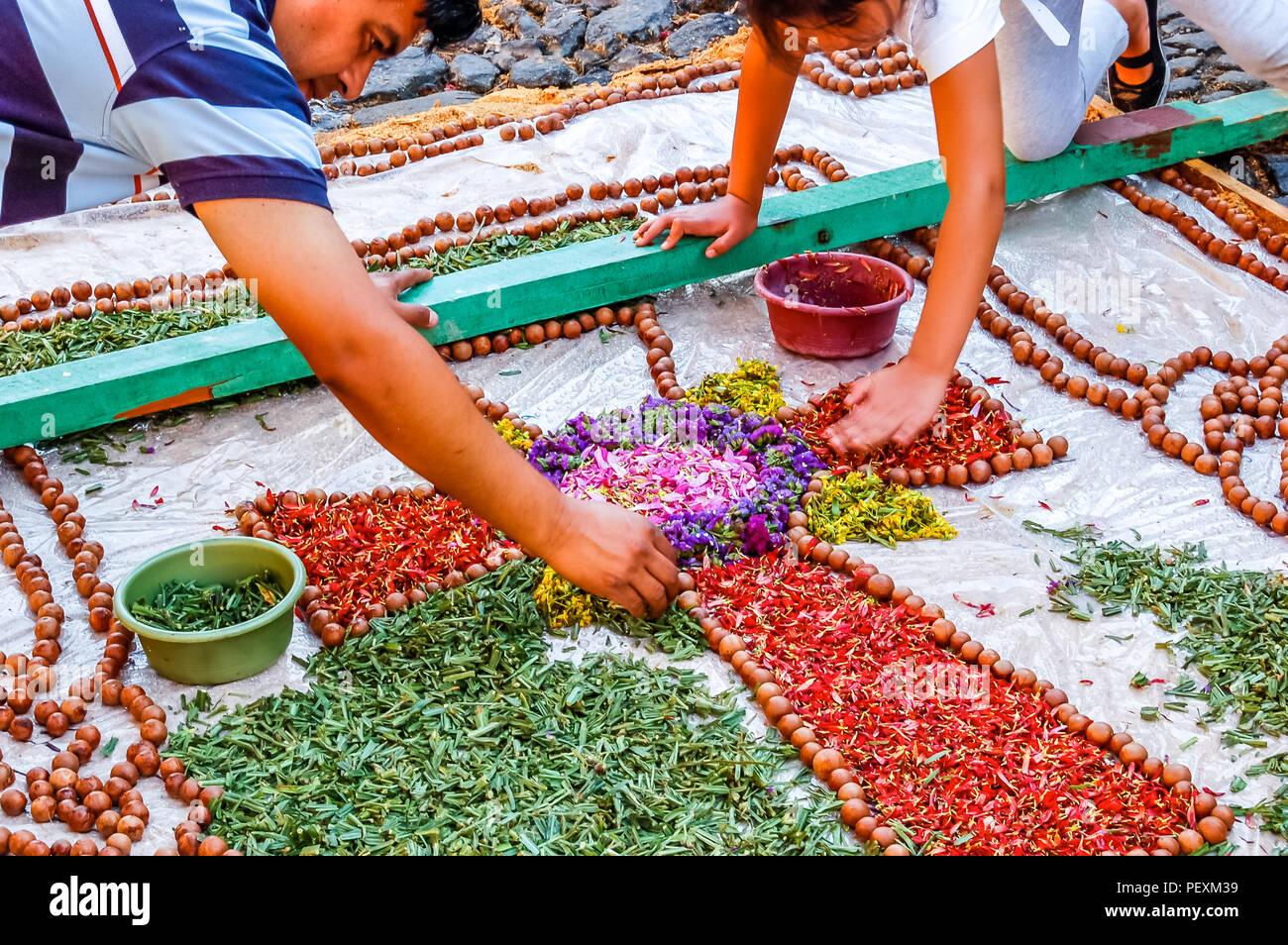 Antigua, Guatemala -  April 10, 2009: Making Good Friday procession carpet in UNESCO World Heritage Site with famous Holy Week celebrations. Stock Photo
