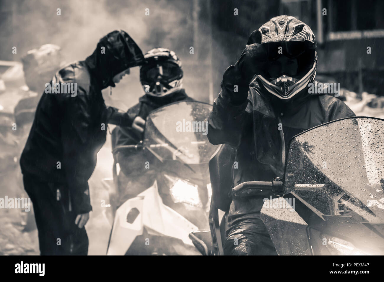 Men on snowmobiles, Whistler, British Columbia, Canada Stock Photo