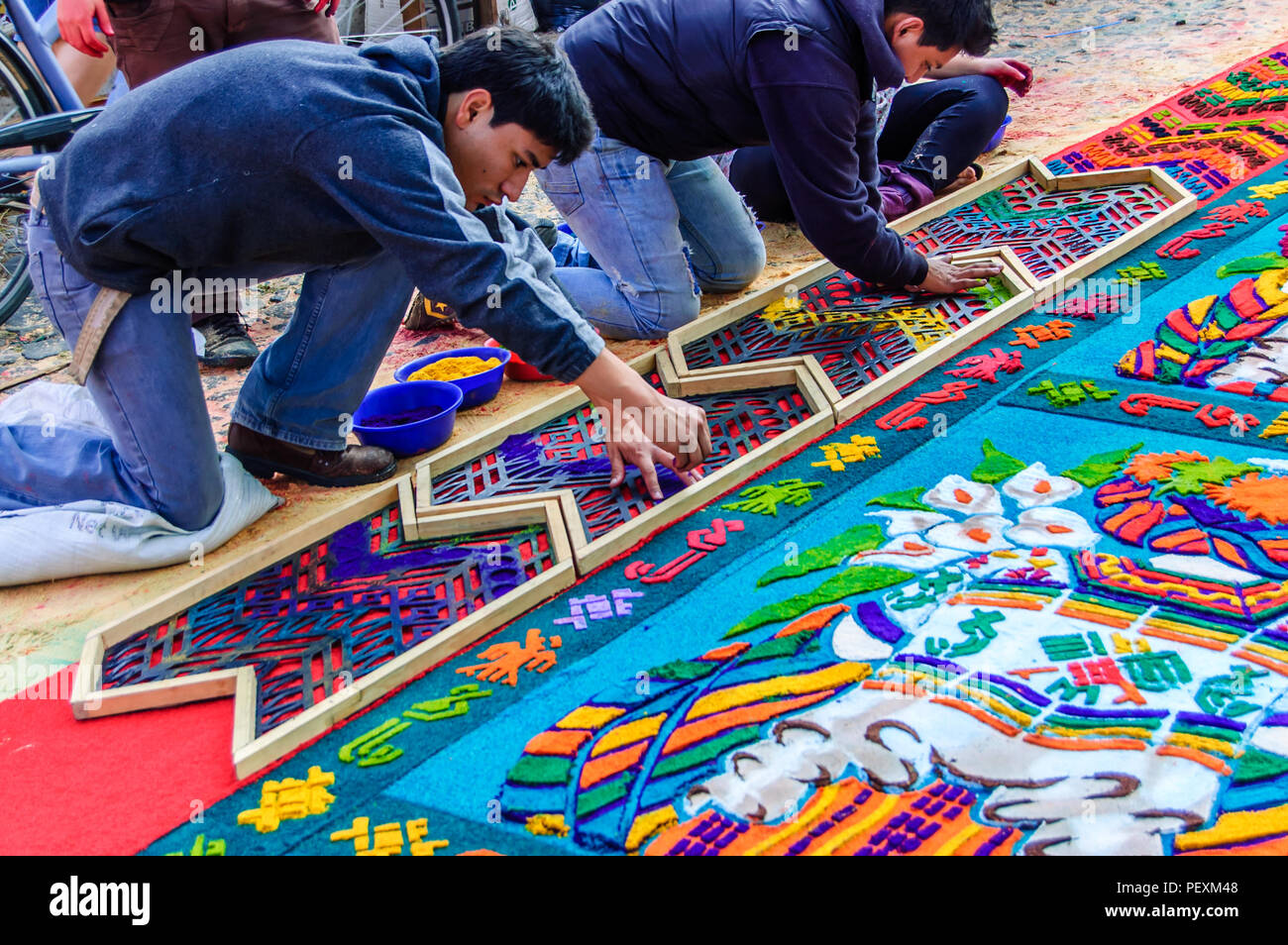 Antigua, Guatemala -  April 1, 2012: Making Palm Sunday procession carpet in UNESCO World Heritage Site with famous Holy Week celebrations. Stock Photo
