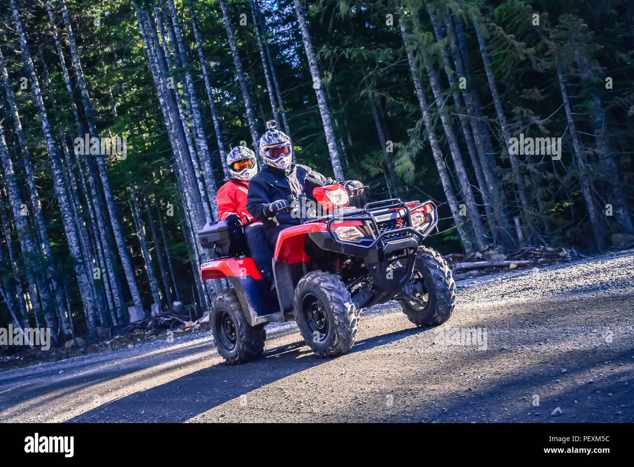 Two people driving quadbike, Callaghan Valley, Whistler, British Columbia, Canada Stock Photo