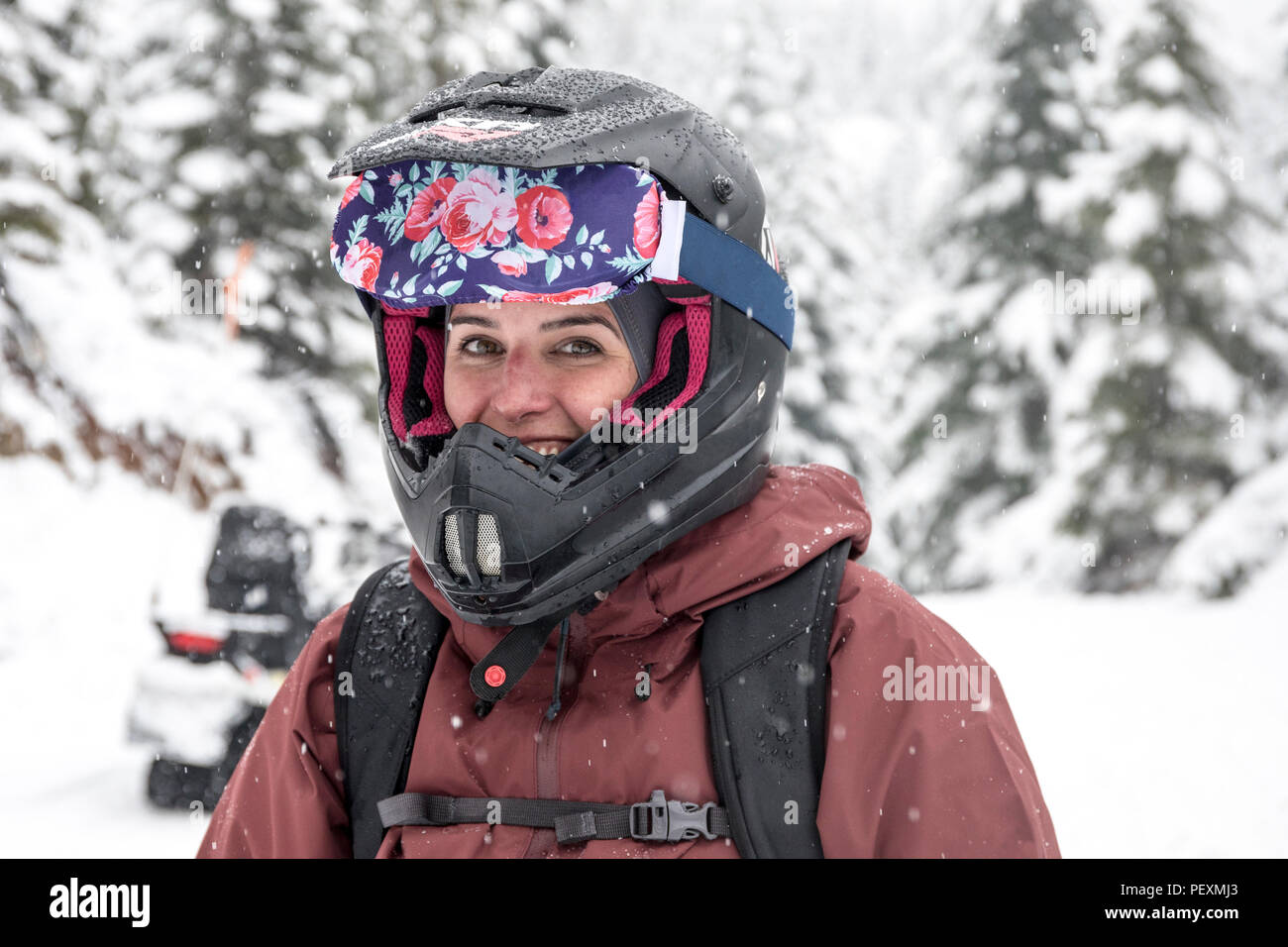 Woman with snowmobile helmet, Whistler, British Columbia, Canada Stock Photo