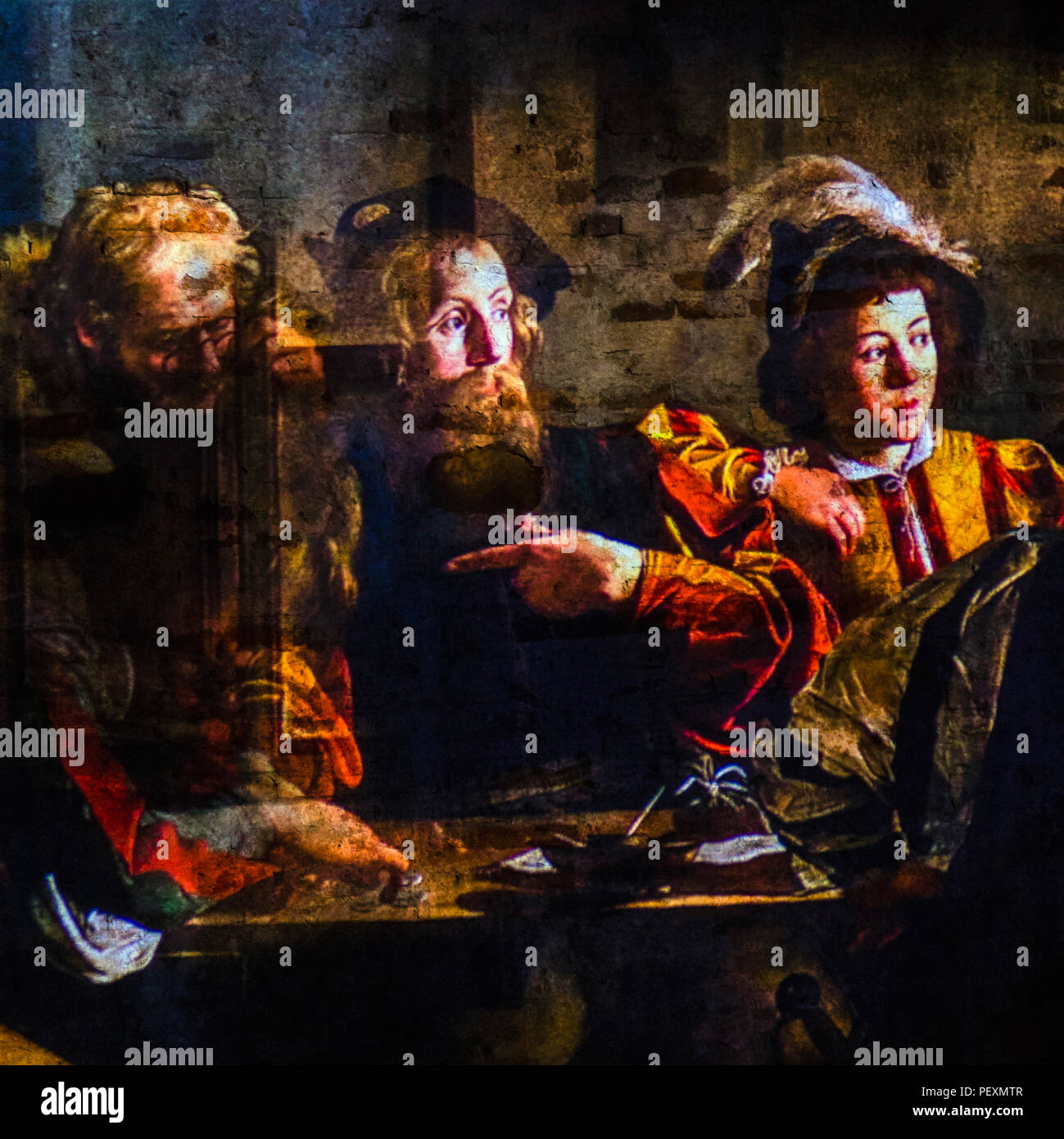 The Calling of Saint Matthew by Caravaggio projected on wall, Lucca, Tuscany, Italy Stock Photo