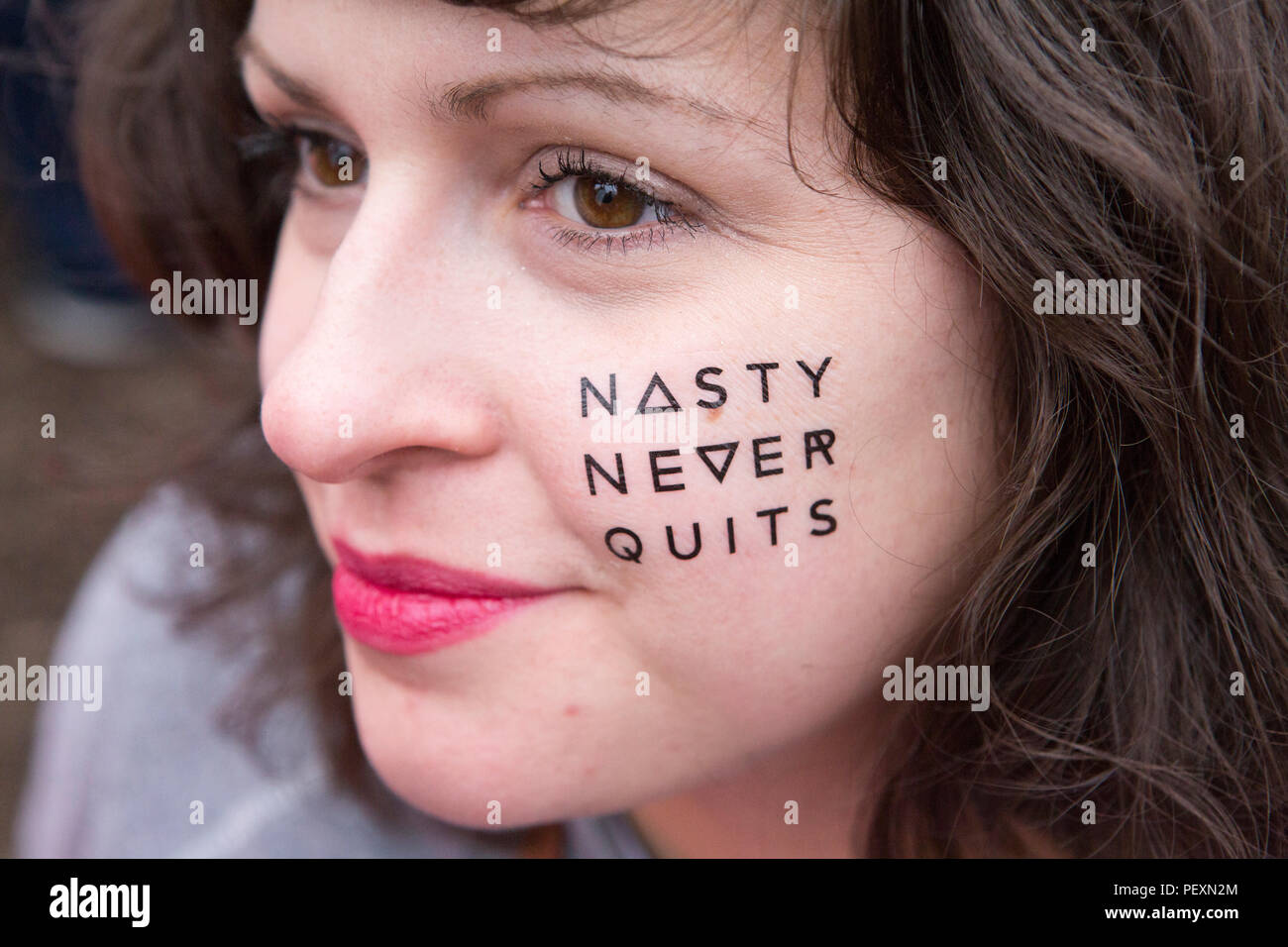 Woman with painted on text on face for Women's March Stock Photo