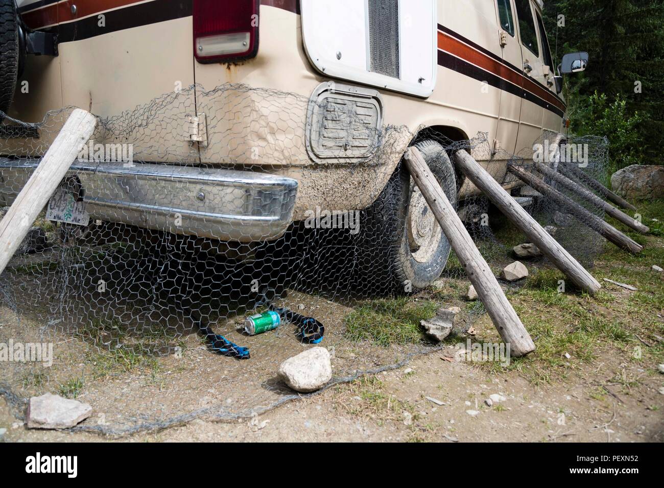 Van protected by chicken wire to prevent porcupines to chew engine plastic parts, Bugaboo Glacier Provincial Park, British Columbia, Canada Stock Photo