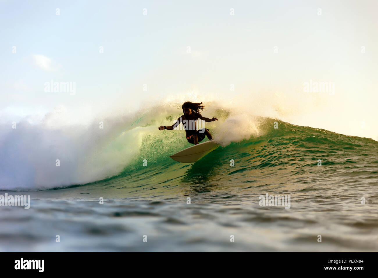 Surfer riding wave in sea Stock Photo