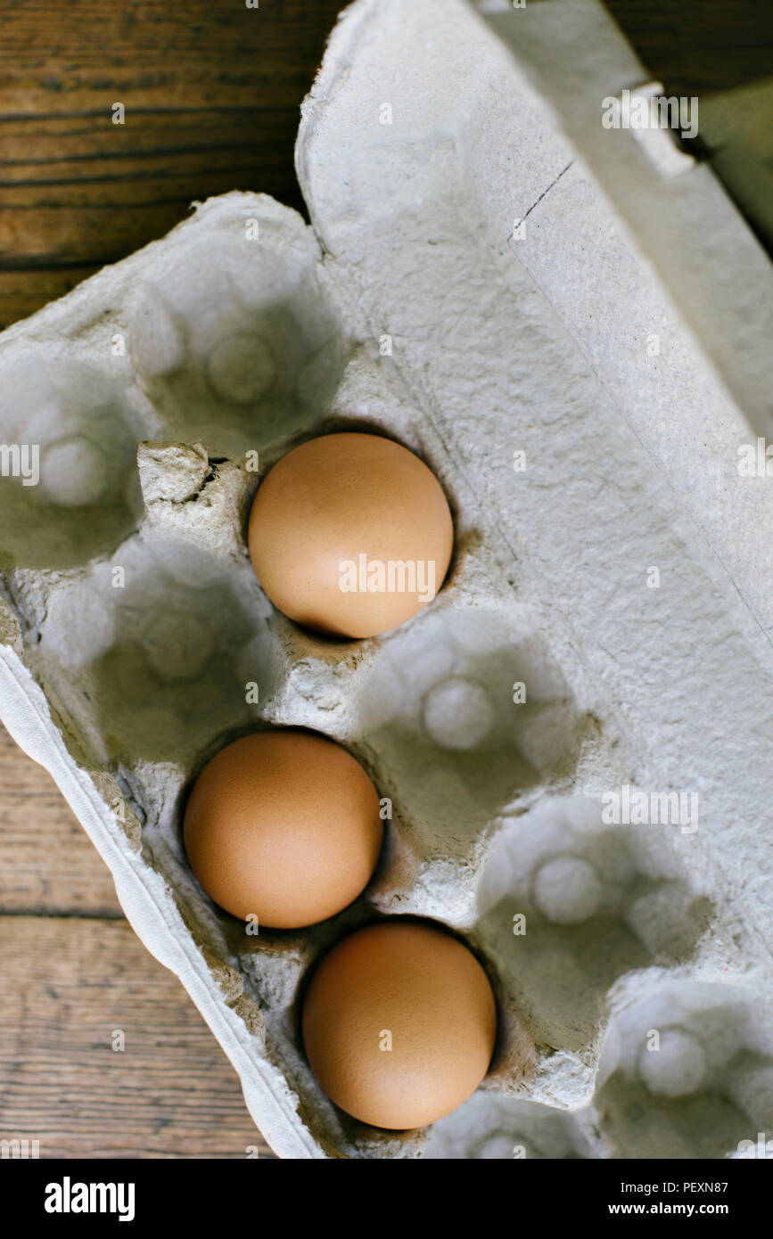 3 fresh eggs in an egg carton Stock Photo