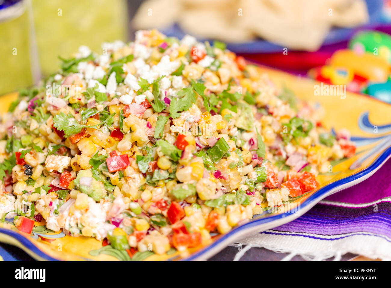Mexican street corn salad with grilled corn in large serving dish Stock