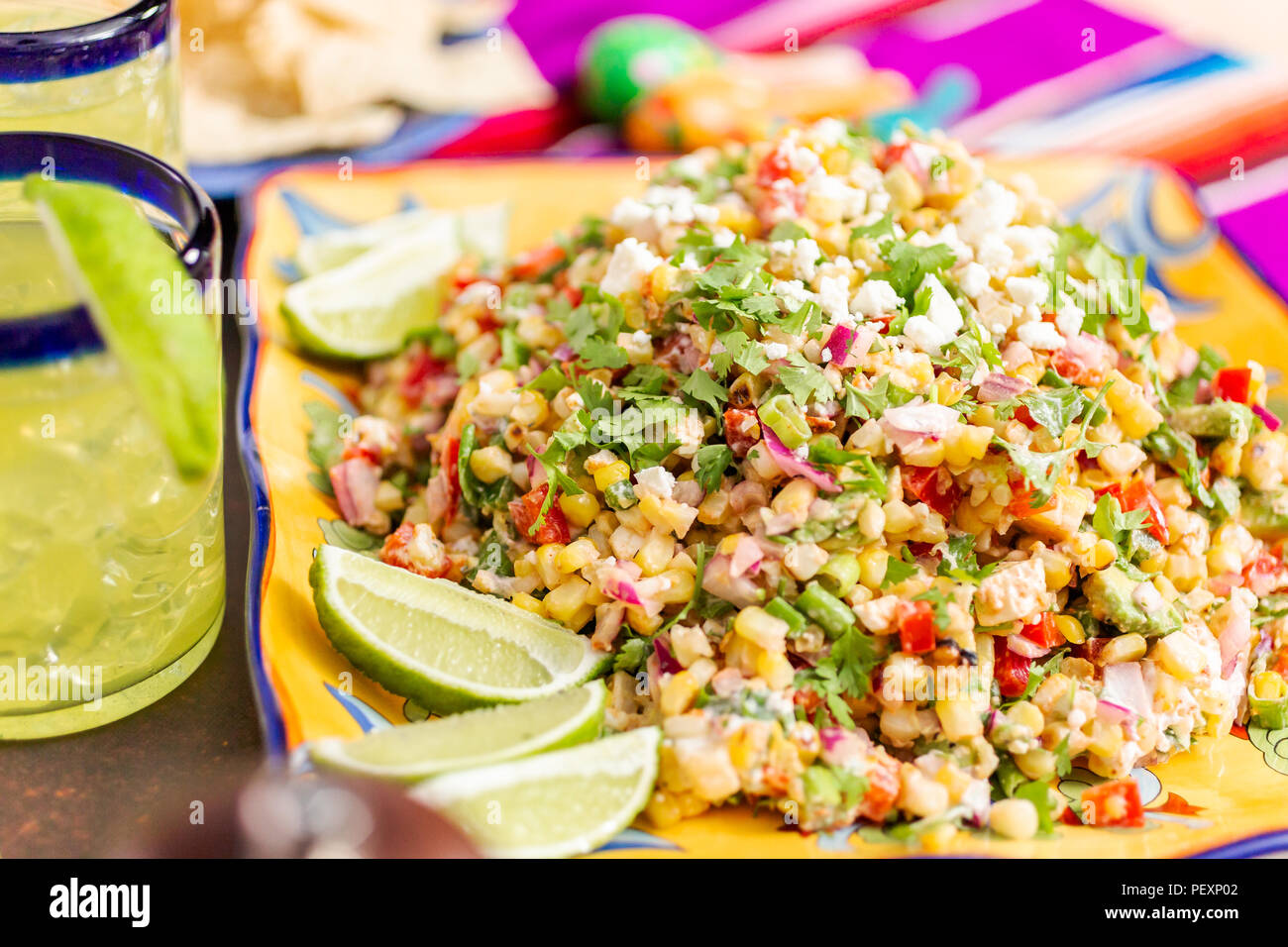 Mexican street corn salad with grilled corn in large serving dish Stock