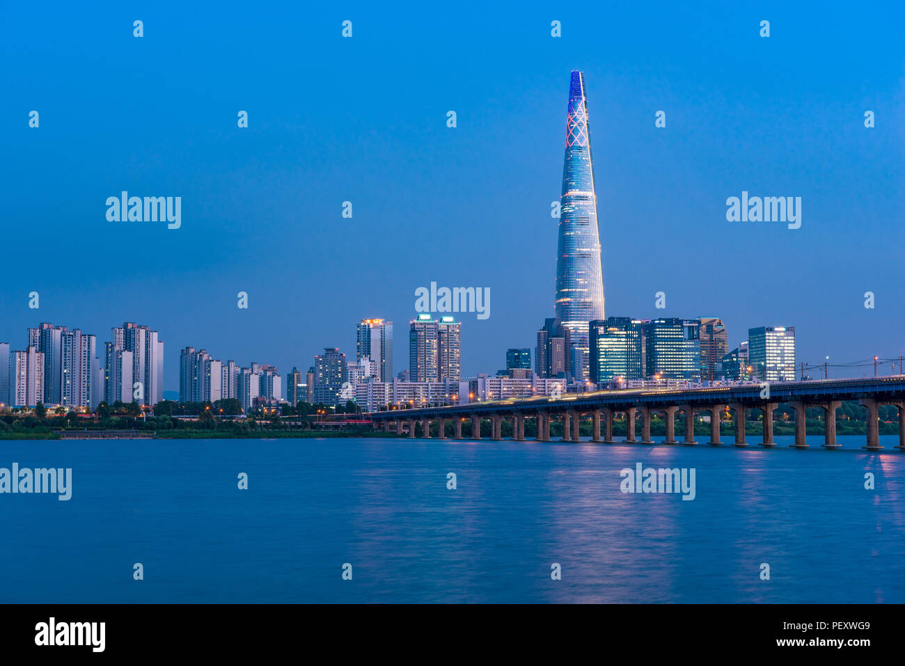 Jamsil railway bridge crossing the Han River and Lotte World Tower in Seoul capital city of South Korea Stock Photo