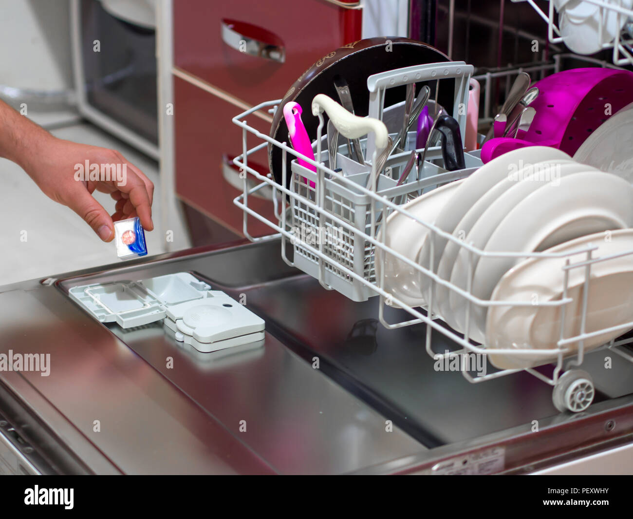 placing the dishwasher detergent for dirty dishes Stock Photo Alamy