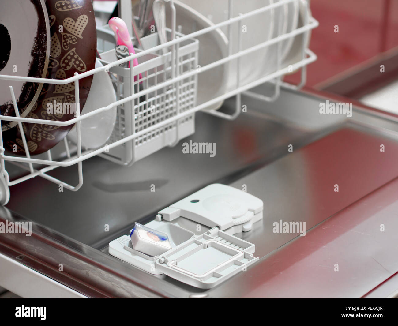 placing the dishwasher detergent for dirty dishes Stock Photo Alamy