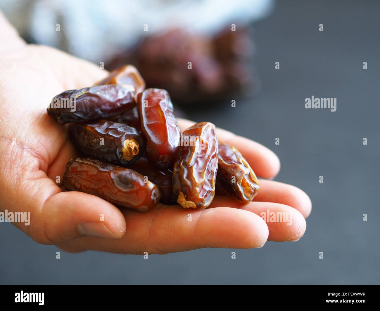 palm fruit in hand. turkish and islamic ramadan fruit Stock Photo