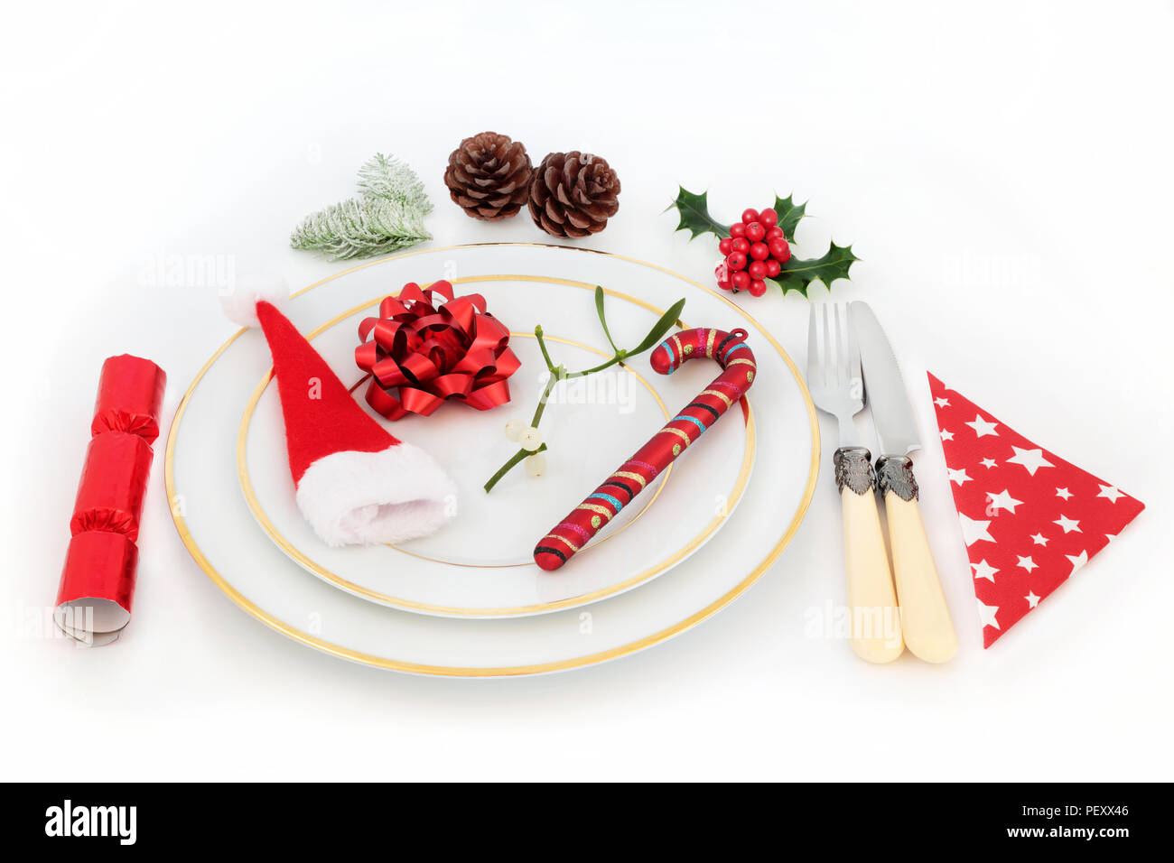 Christmas dinner table setting with white porcelain plates, cutlery ...