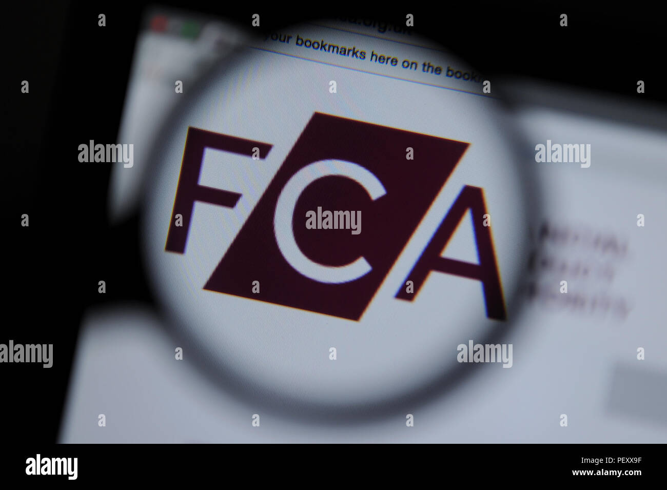The The Financial Conduct Authority website seen through a magnifying glass Stock Photo