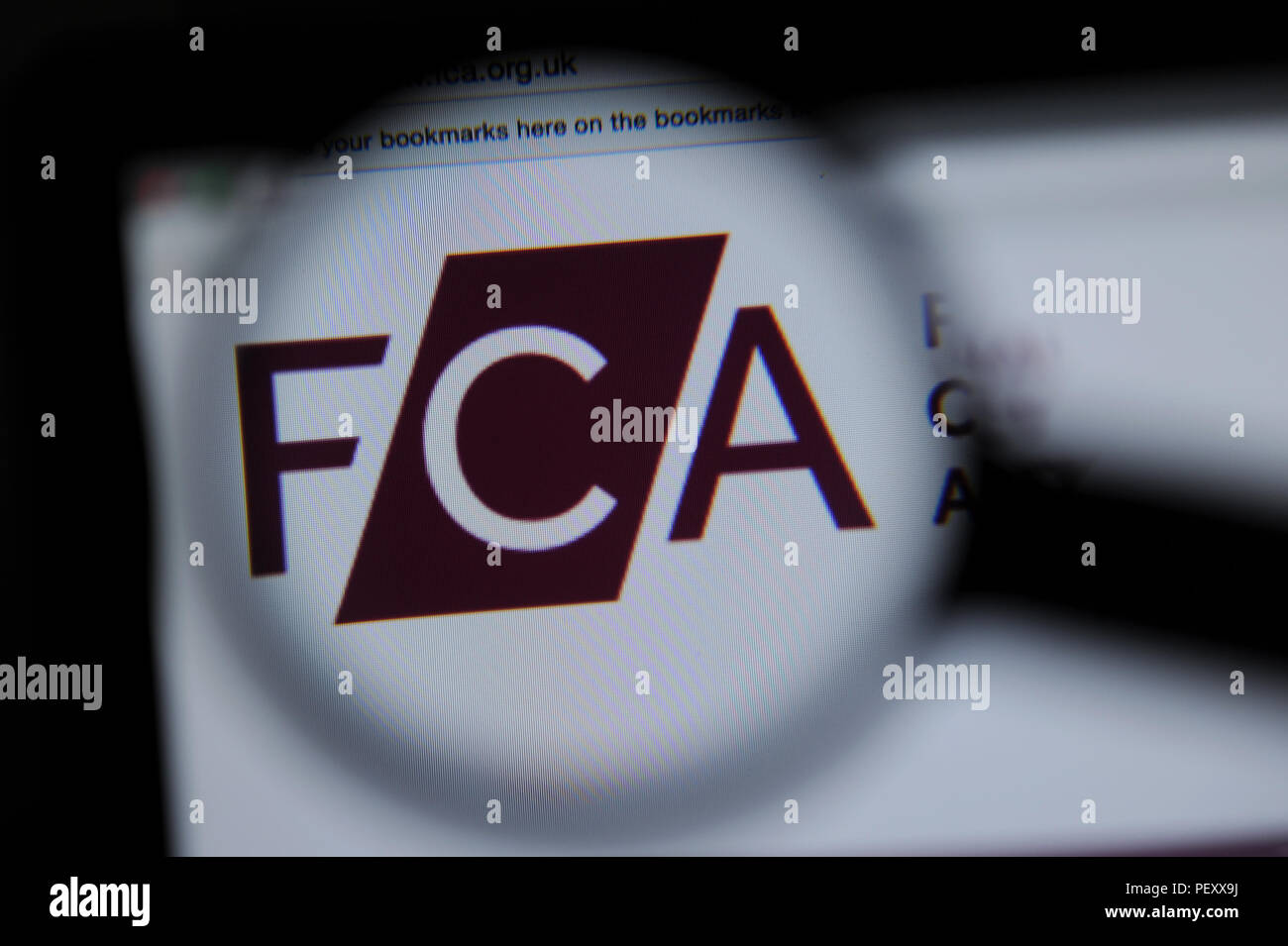 The Financial Conduct Authority website seen through a magnifying glass Stock Photo