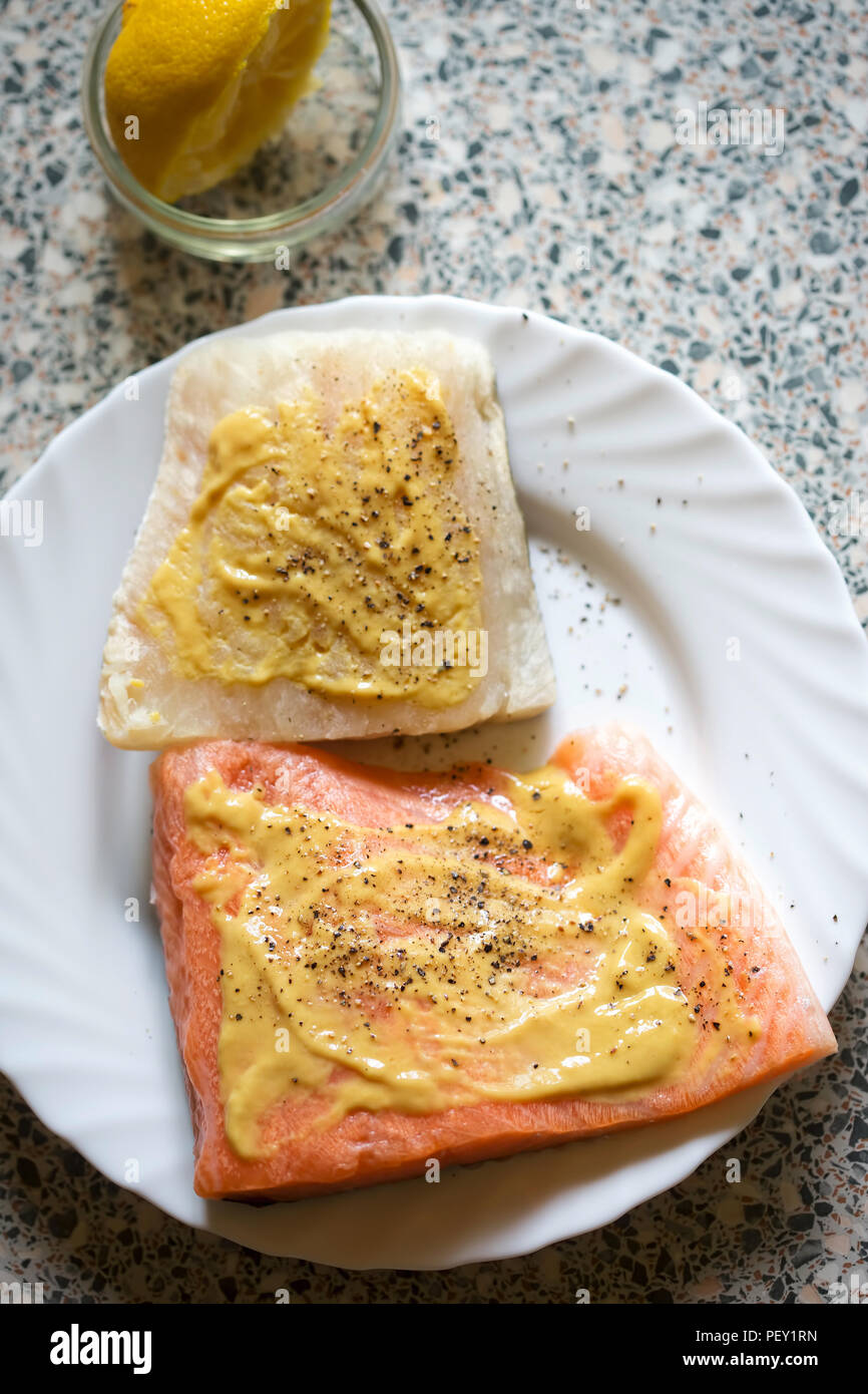 Oven ready raw halibut and salmon fillets with mustard Stock Photo Alamy