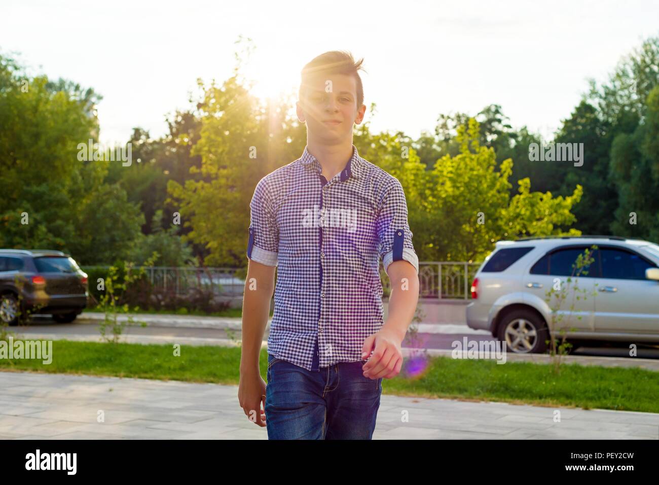 Outdoor portrait of a teenage boy 14, 15 years old. Urban background Stock Photo