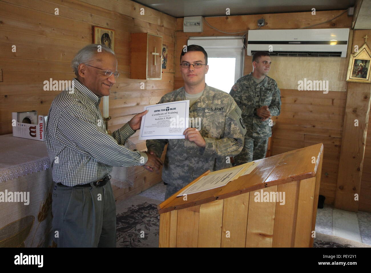 Dr. Felipe Gonzalez, The Medical Director Of The Emergency Medical  Technology Program For Central Texas College-Europe, Presents A Certificate  To U.s. Army Spc. Nicholas J. Walker, A North Carolina National Guard  Soldier
