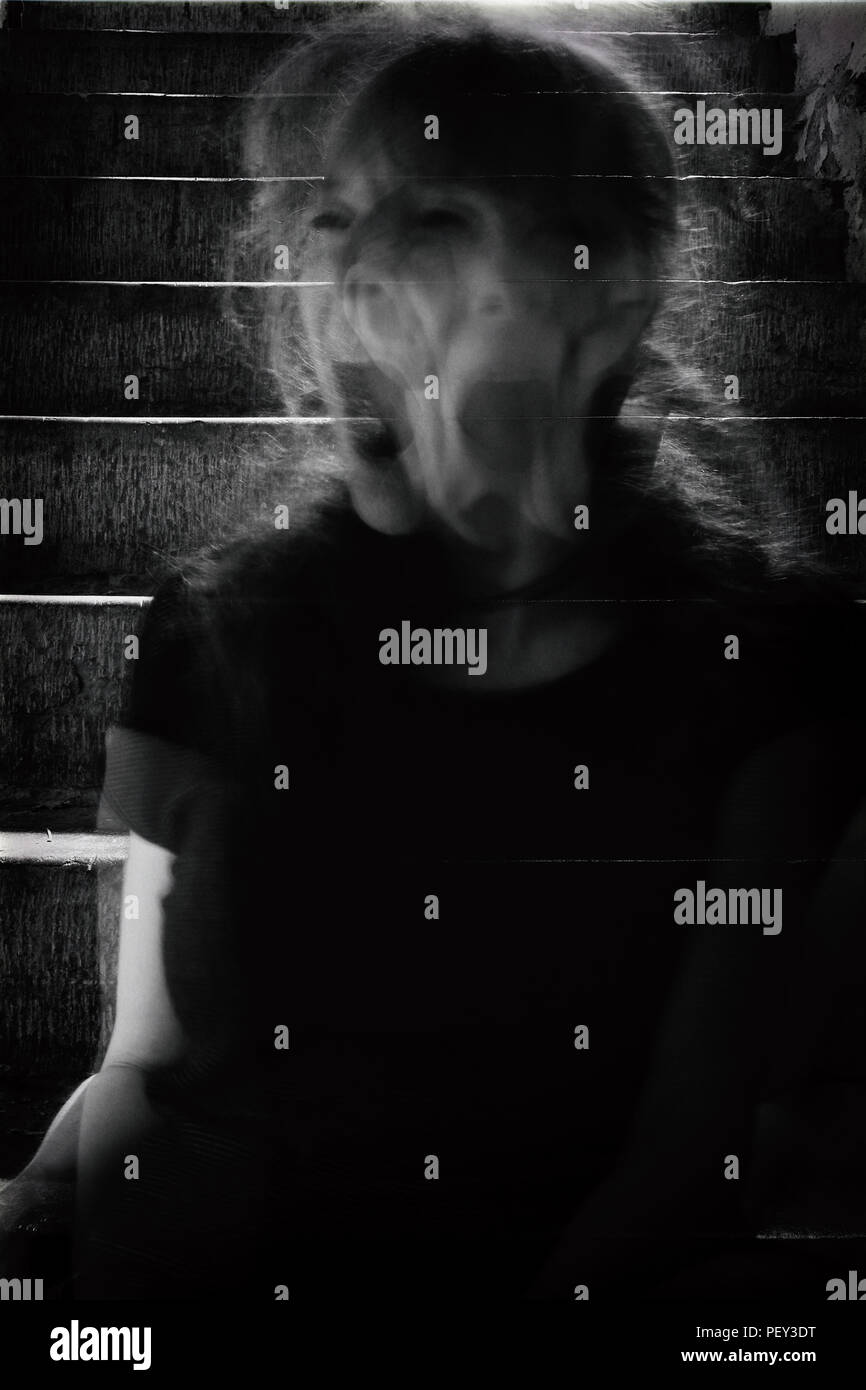 Dark, black and white, rough image of unrecognizable woman in motion ...