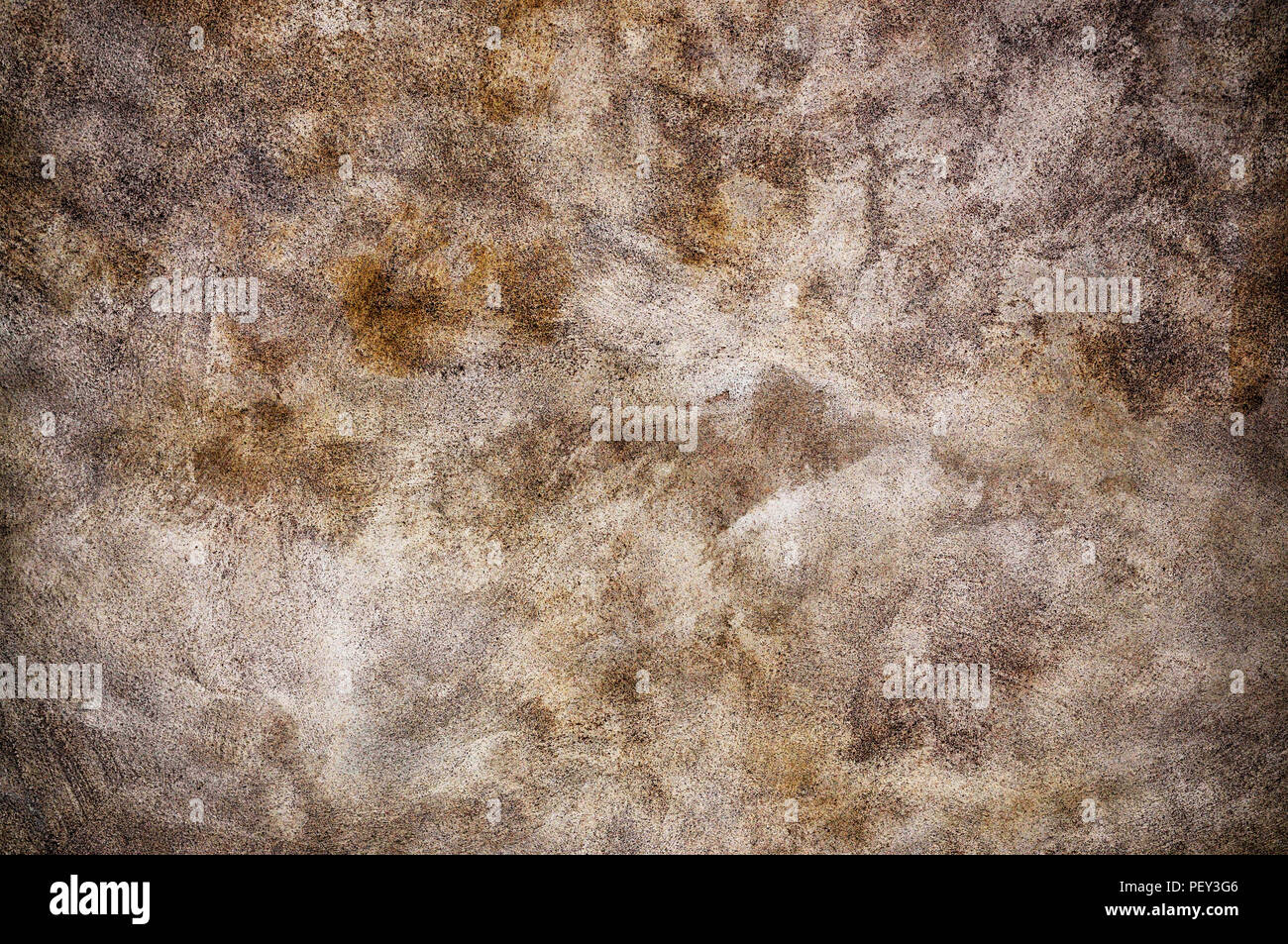 Closeup of old rough stone wall with strokes and patterns in earth colors. Stock Photo