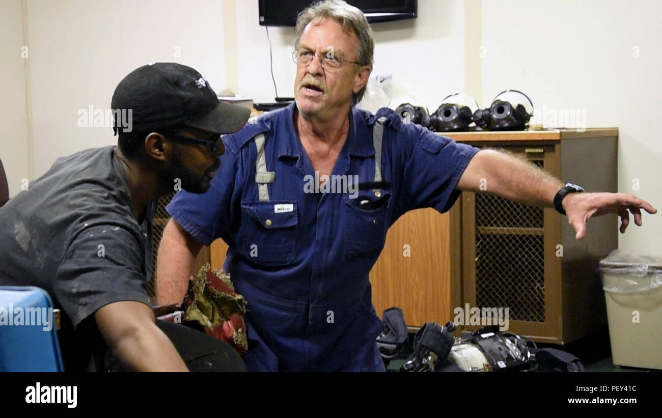 160217-N-OU129-010 GULF OF THAILAND (Feb. 17, 2016) Able-Body Seaman Bryan Howell (left) and Chief Officer Brad Shelly demonstrate search techniques during a zero-visibility drill aboard USNS 1st LT Jack Lummus (T-AK 3011) while anchored in the Gulf of Thailand, Feb 17. Lummus is a Military Sealift Command Maritime Prepositioning ship supporting Exercise Cobra Gold 2016. (U.S. Navy photo by Mass Communication Specialist 3rd Class Joshua Fulton/Released) Stock Photo