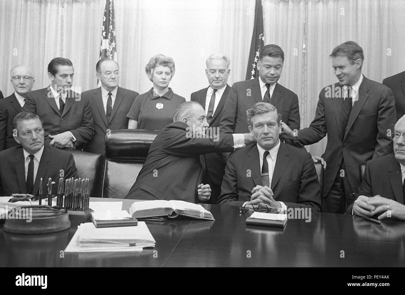 In this July 29, 1967, photo provided by the U.S. Library of Congress, President Lyndon B. Johnson interacts with members of the National Advisory Commission on Civil Disorders (Kerner Commission) in the White House. The commission's report, issued in 1968, detailed the root causes of racial tensions in America and provided guidelines to ease civil unrest in the U.S. The report called out unfair hiring practices across news agencies in America, helping to eliminate discriminatory hiring practices across the U.S. mass media. (Photo courtesy Library of Congress) Stock Photo