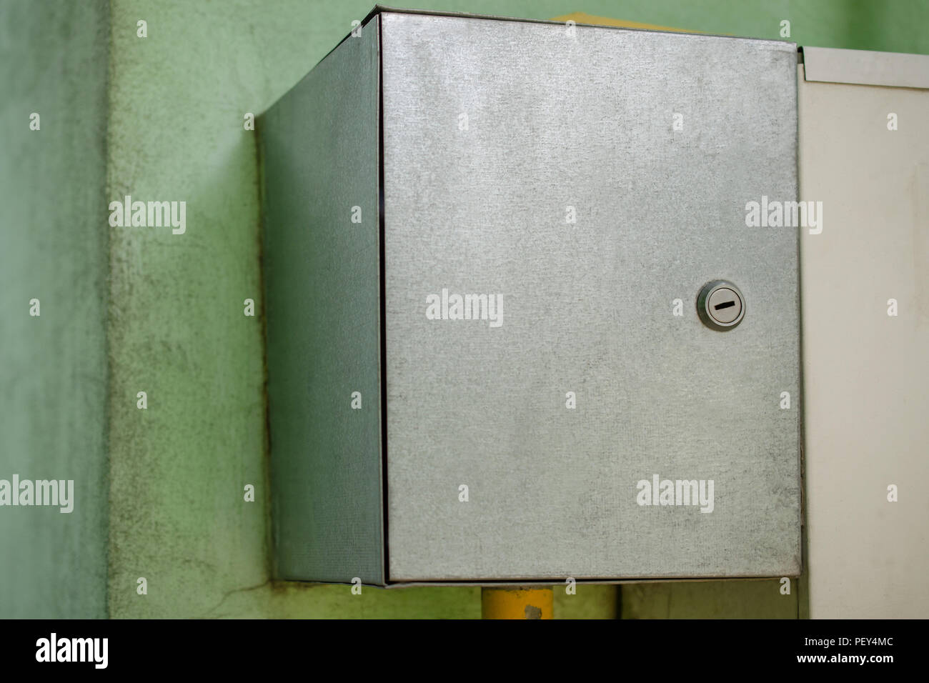 Gray electric or gas switch box, hanging on the wall. Equipment of a private