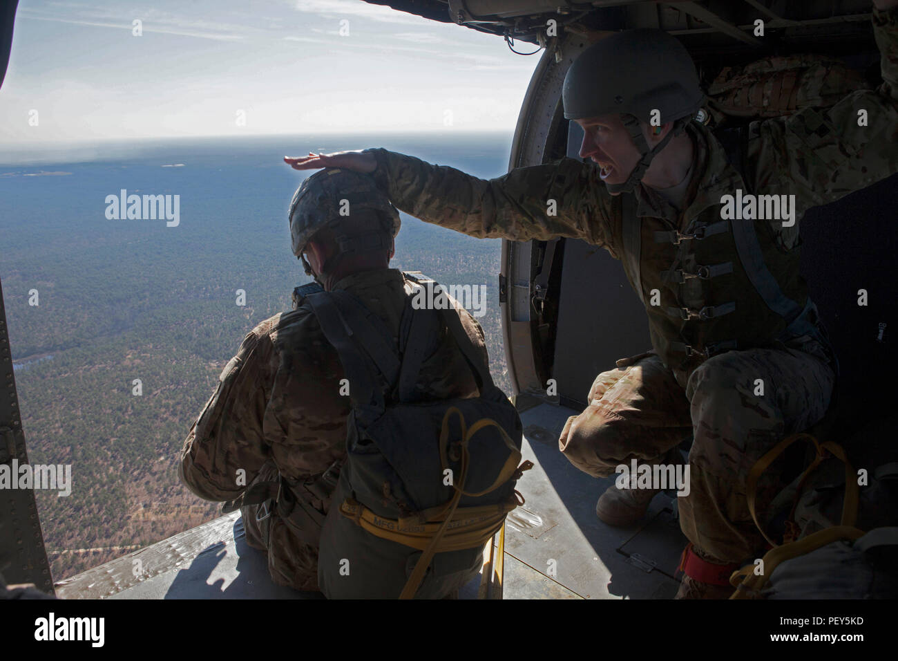 U.S. Army jumpmaster gives the command to a fellow paratrooper to jump