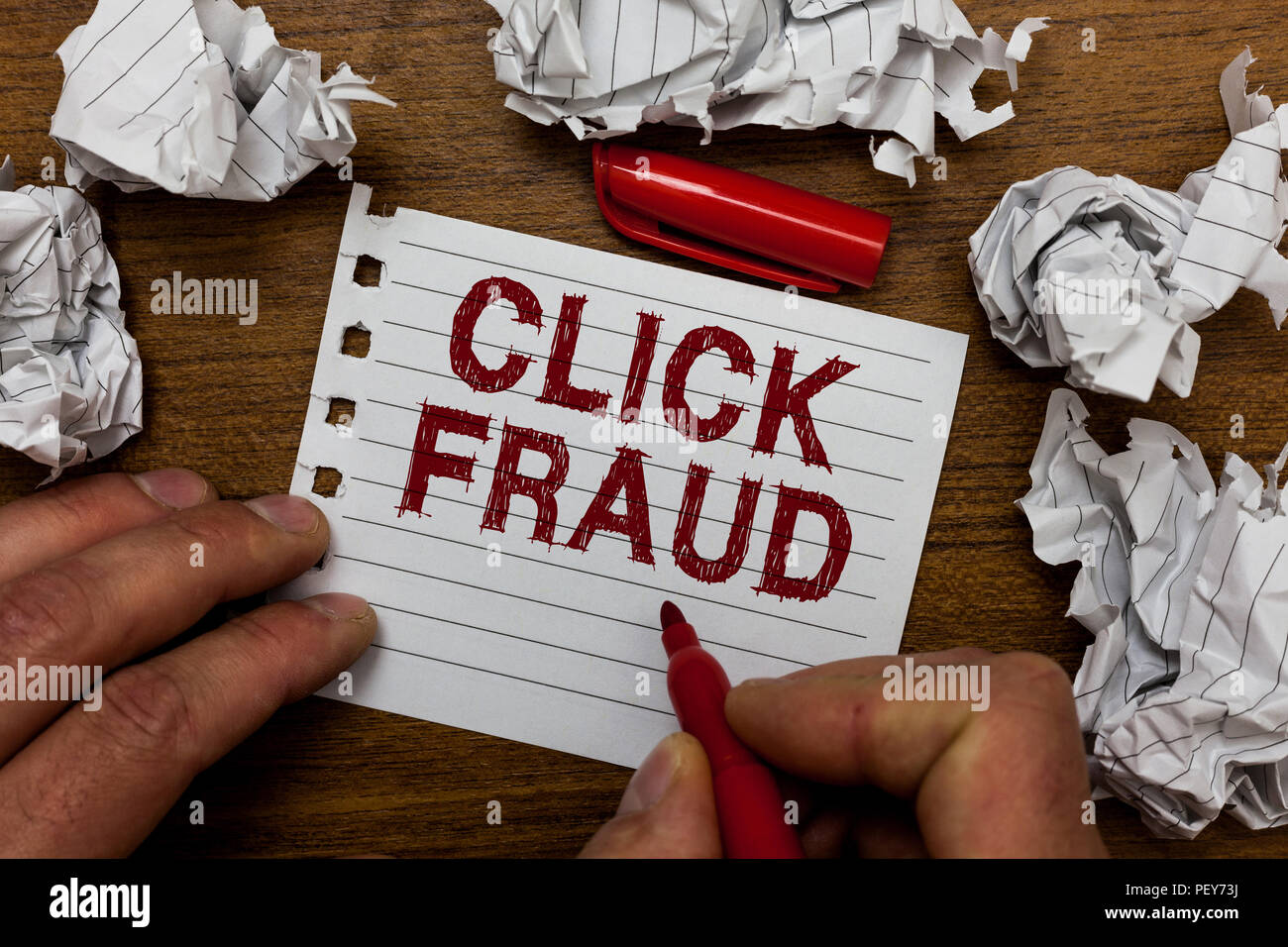 Writing note showing Click Fraud. Business photo showcasing practice of repeatedly clicking on advertisement hosted website Man holding marker noteboo Stock Photo