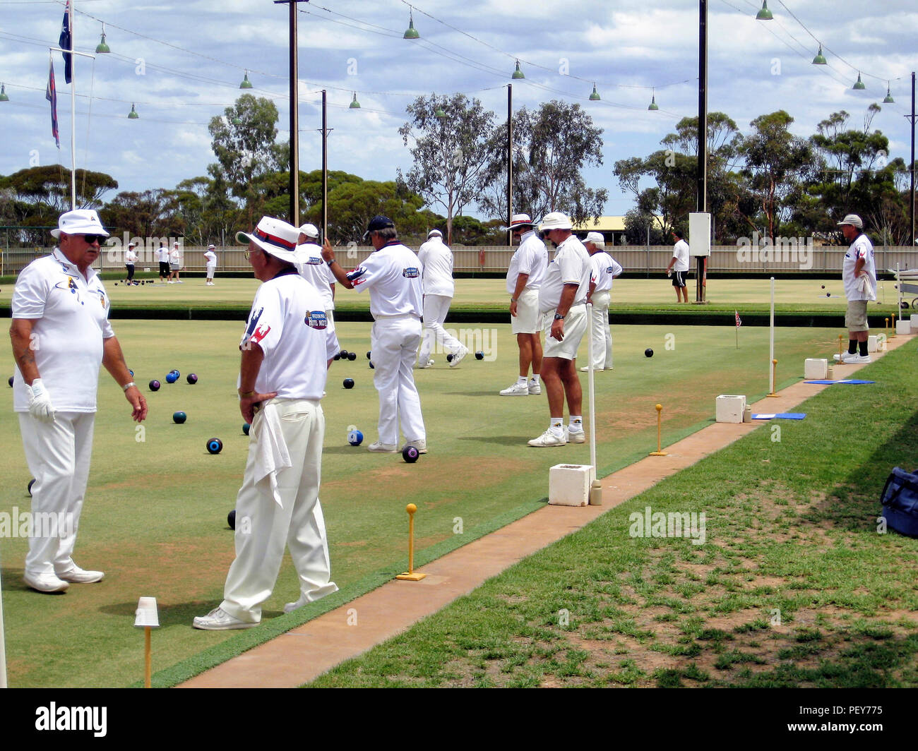 Playing bowls. Group of elderly people bowling on a bowling green in Australia Stock Photo