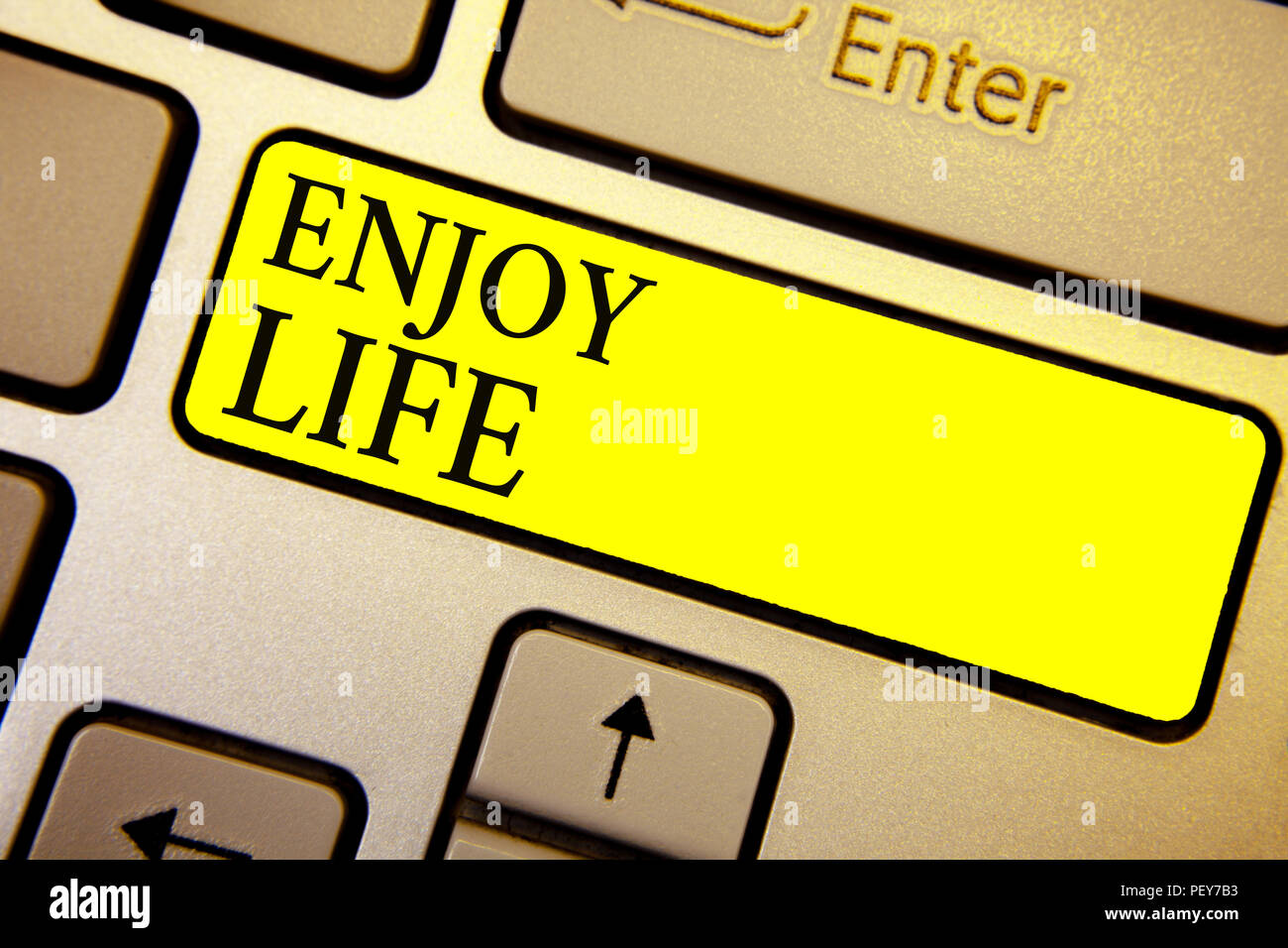 Handwriting text Enjoy Life. Concept meaning Any thing, place,food or person, that makes you relax and happy Keyboard yellow key Intention create comp Stock Photo
