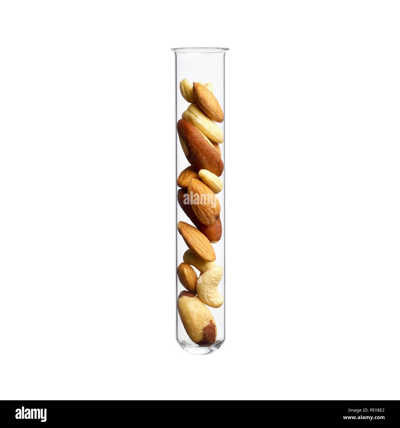 Mixed nuts in test tube, studio shot. Stock Photo