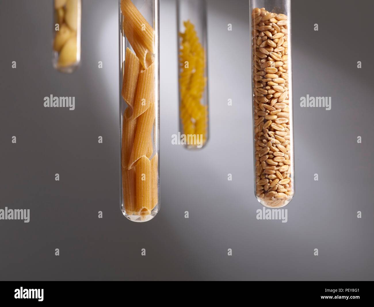 Carbohydrate foods in test tubes, studio shot. Stock Photo