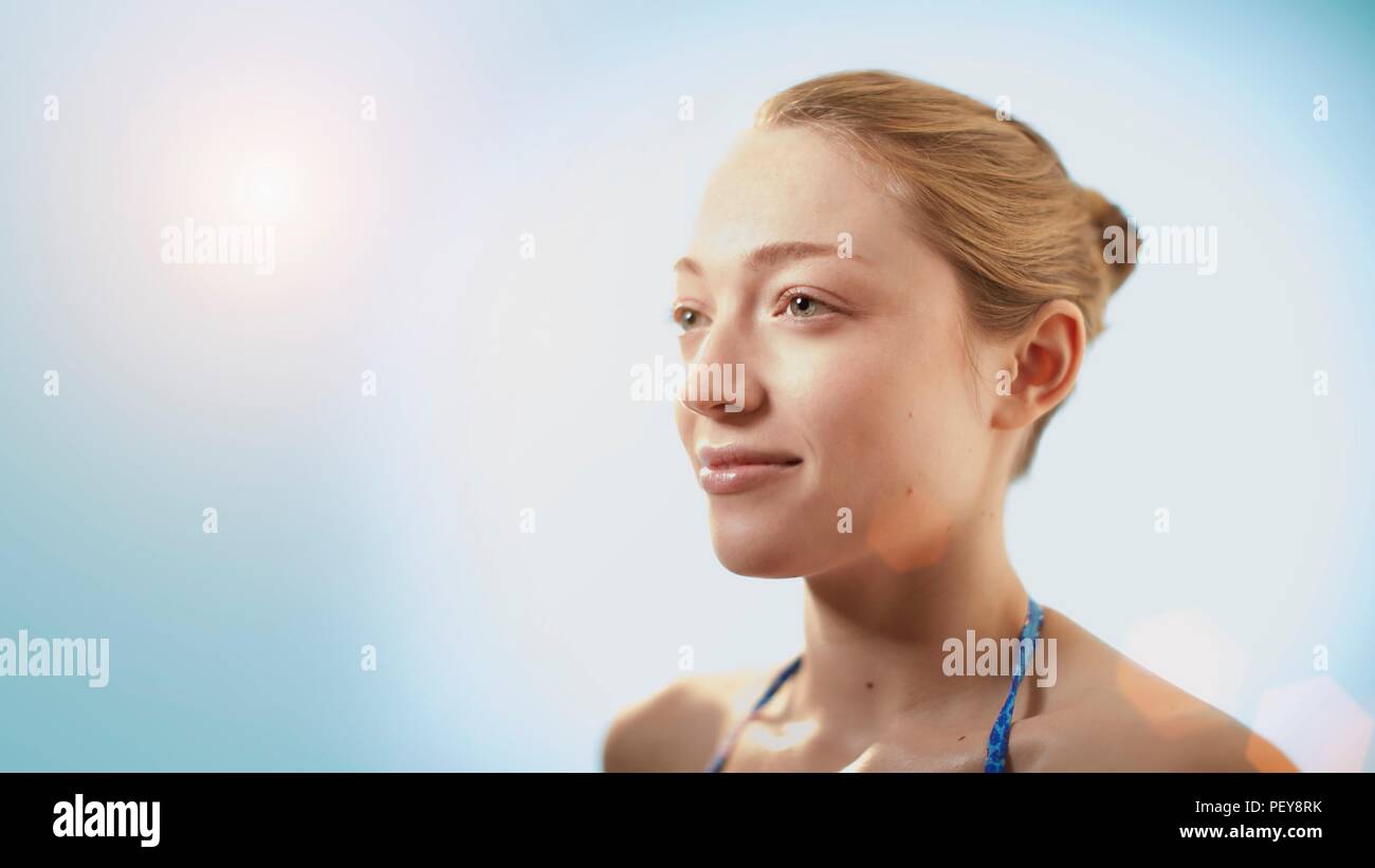 Woman in sunlight, smiling Stock Photo - Alamy