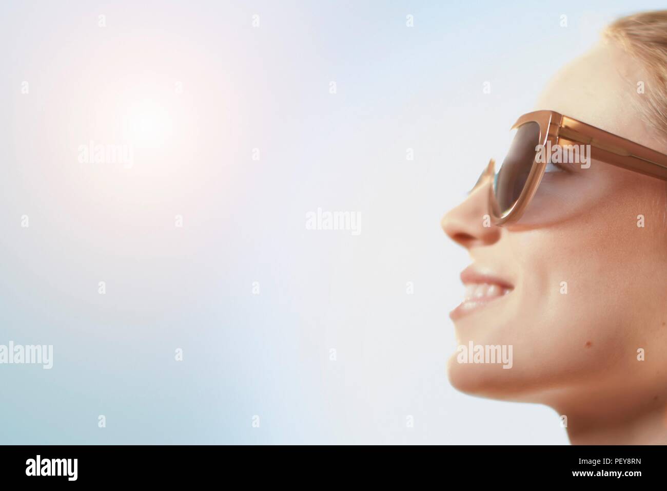 Woman wearing sunglasses, smiling. Stock Photo