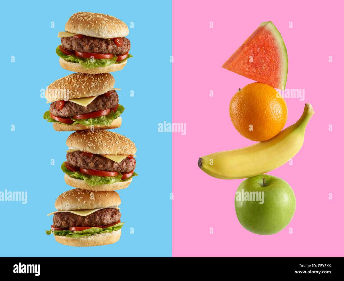 Stack of hamburgers and stack of fruit. Stock Photo