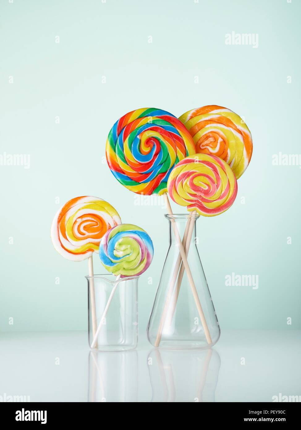 Laboratory glassware with lollipops. Stock Photo