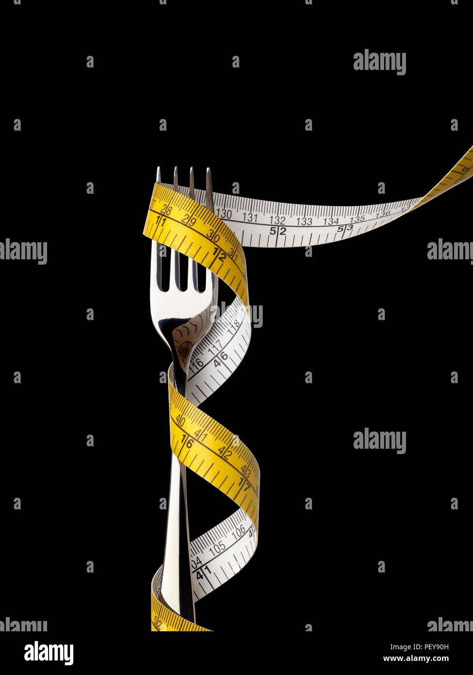 Fork with tape measure. Stock Photo