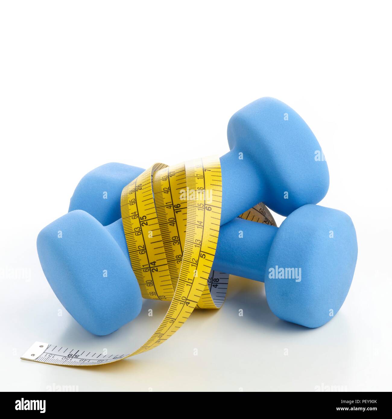 Dumbbells with tape measure. Stock Photo