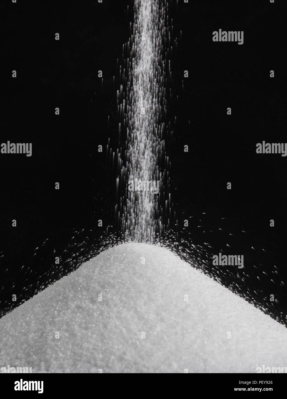 Salt pouring into a pile. Stock Photo