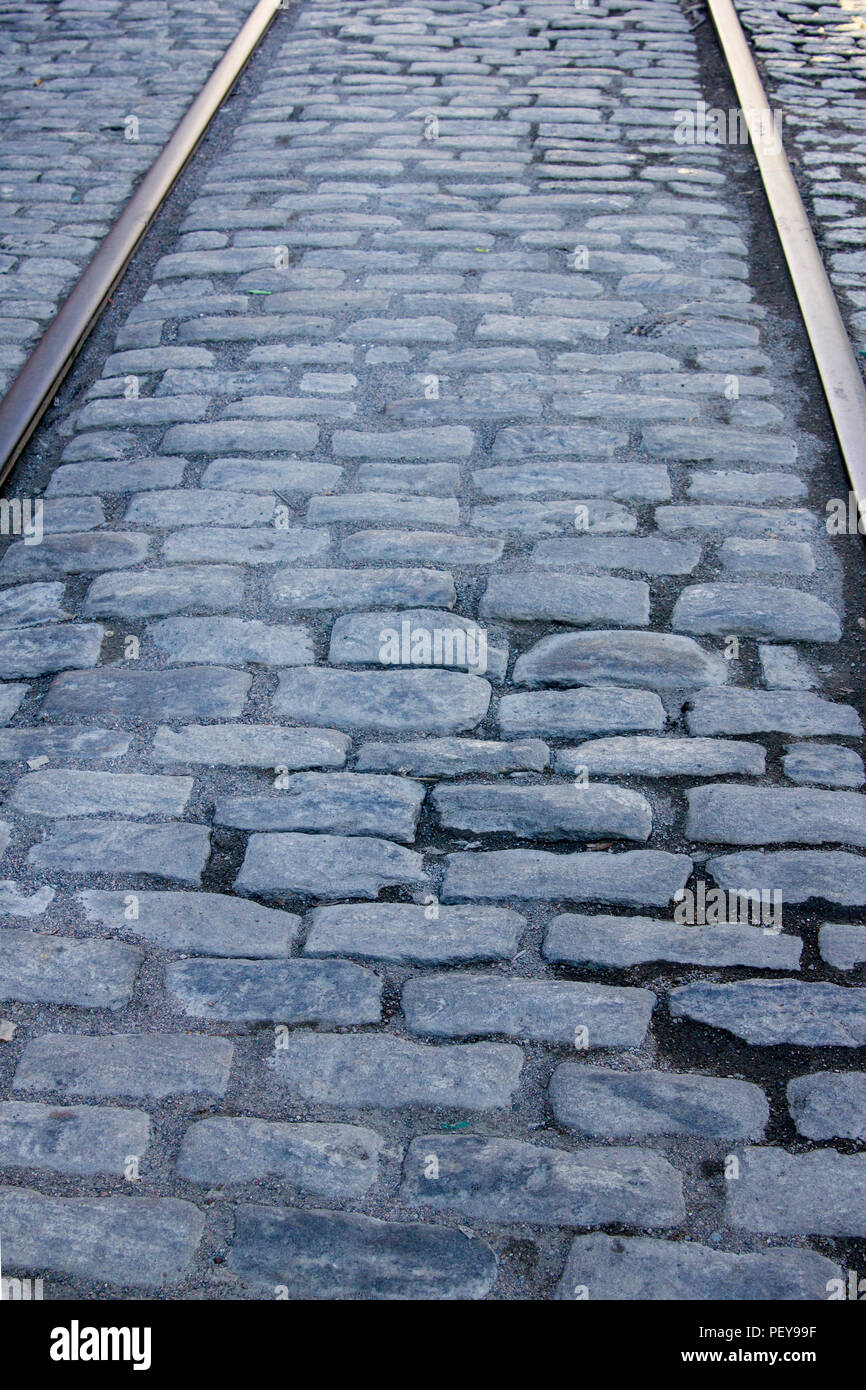 Rail tracks in cobblestone street Stock Photo