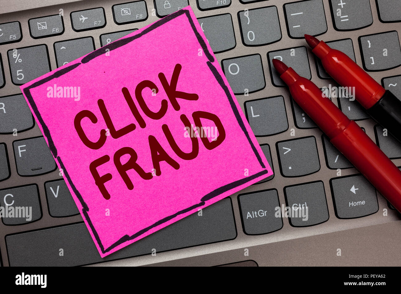 Text sign showing Click Fraud. Conceptual photo practice of repeatedly clicking on advertisement hosted website Pink paper keyboard Inspiration commun Stock Photo