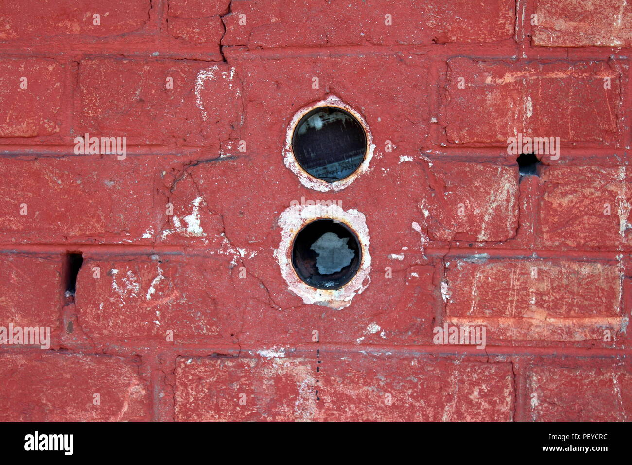 Two round electrical outlet boxes without wires mounted with plaster