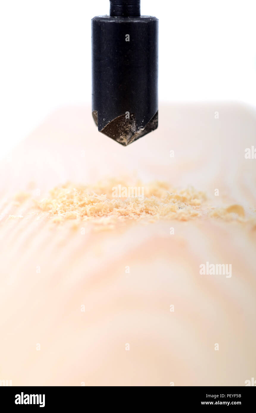 Countersink drill bit in use, Drilling hole in wood, carpenter woodworking concept Stock Photo